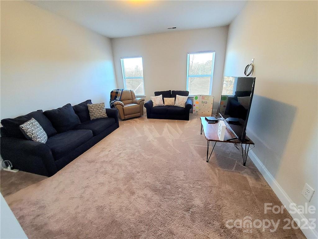 10013 Sunset Ridge Midland, NC 28107 - Photo 24 of 45 a living room with furniture and a window