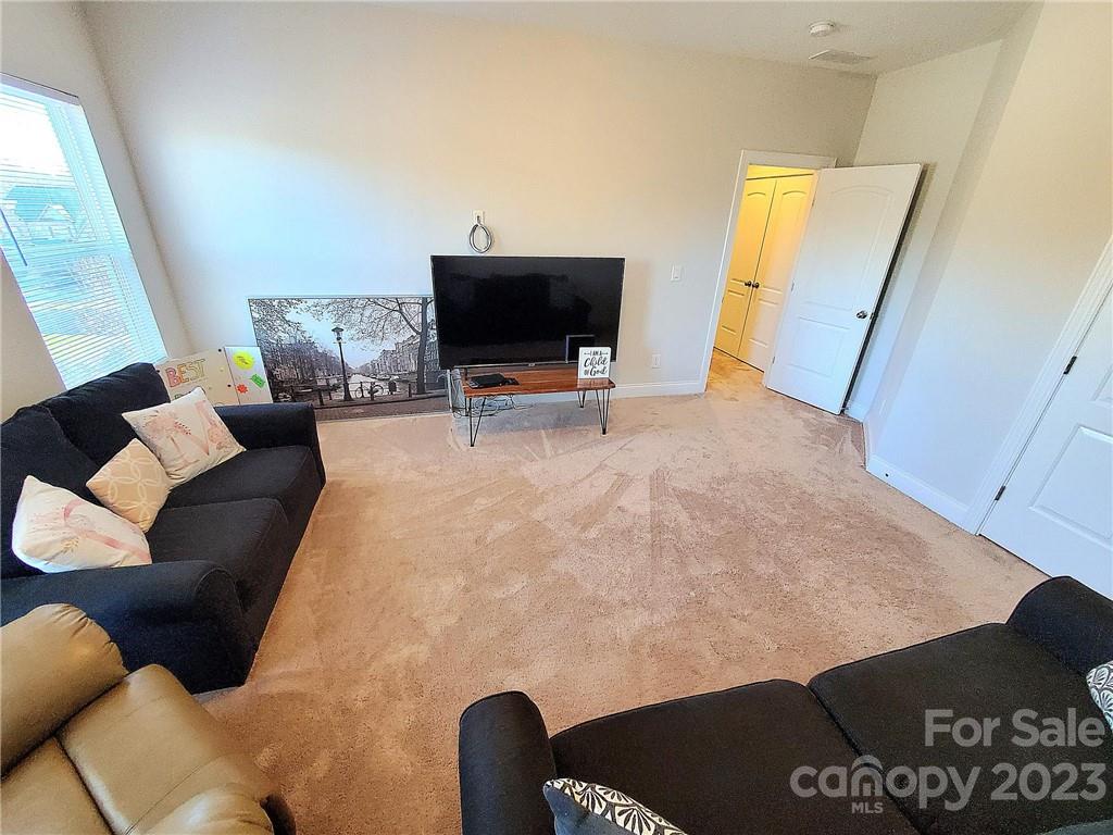 10013 Sunset Ridge Midland, NC 28107 - Photo 25 of 45 a living room with furniture and a flat screen tv
