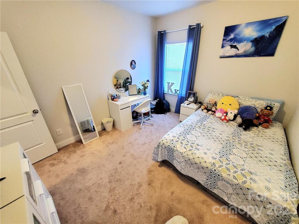 10013 Sunset Ridge Midland, NC 28107 - Photo 26 of 45 a bedroom with a bed and wooden floor