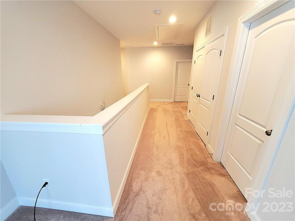 10013 Sunset Ridge Midland, NC 28107 - Photo 31 of 45 a view of a hallway with wooden floor