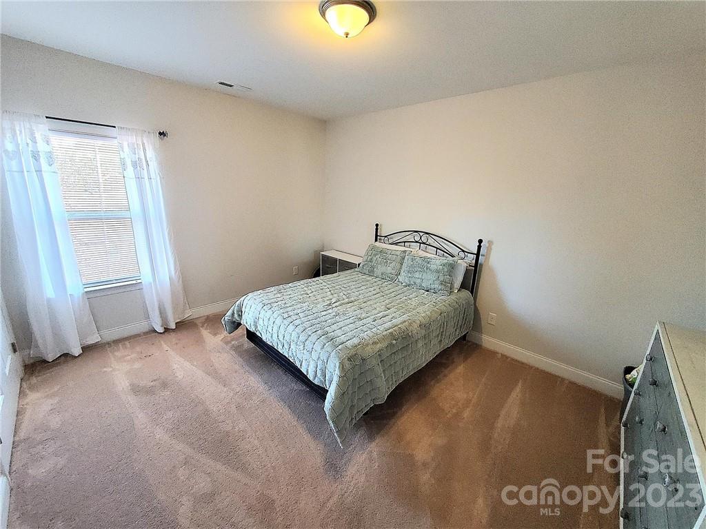 10013 Sunset Ridge Midland, NC 28107 - Photo 32 of 45 a bedroom with a bed and a window
