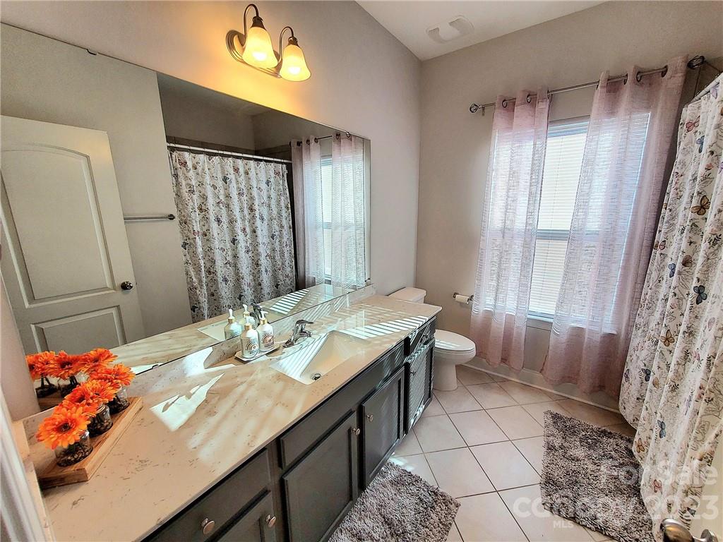 10013 Sunset Ridge Midland, NC 28107 - Photo 34 of 45 a bathroom with a double vanity sink mirror and shower
