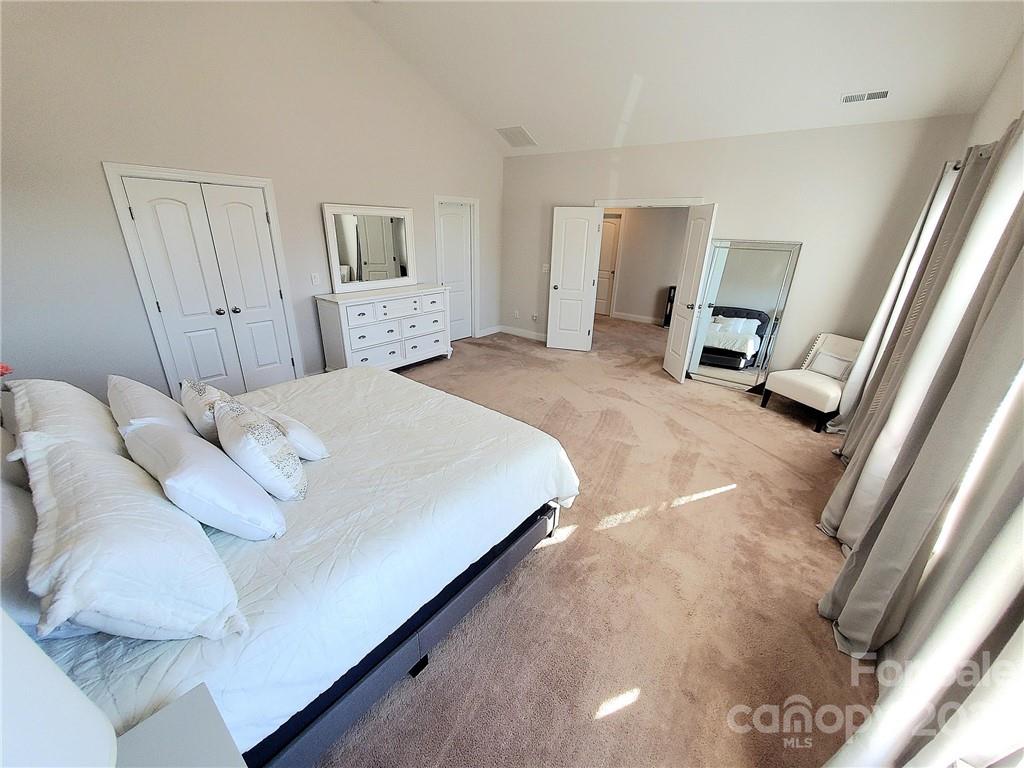 10013 Sunset Ridge Midland, NC 28107 - Photo 38 of 45 a bedroom with a bed and a mirror