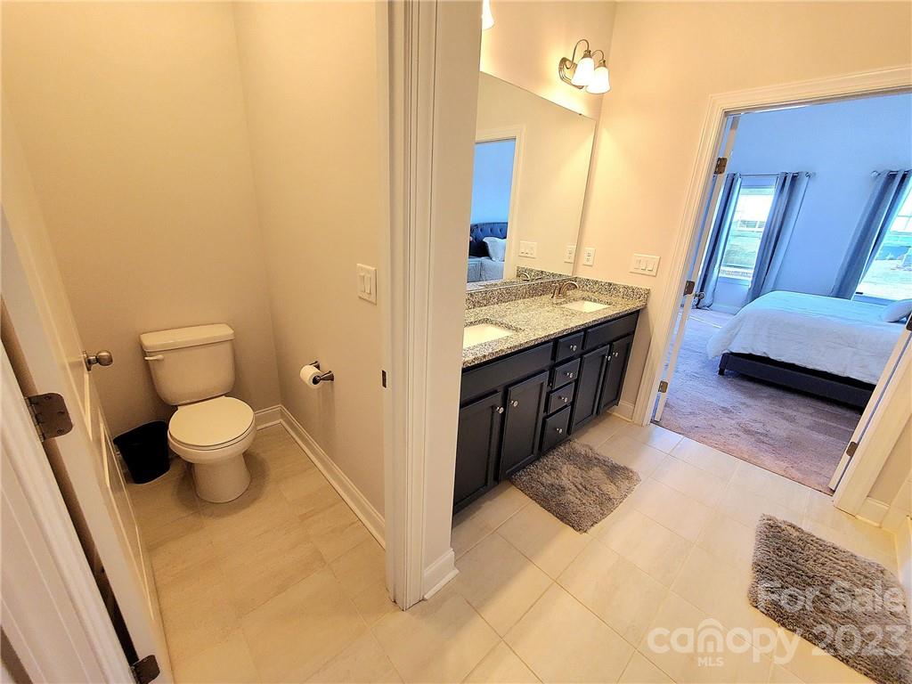 10013 Sunset Ridge Midland, NC 28107 - Photo 40 of 45 a spacious bathroom with a granite countertop sink and a mirror