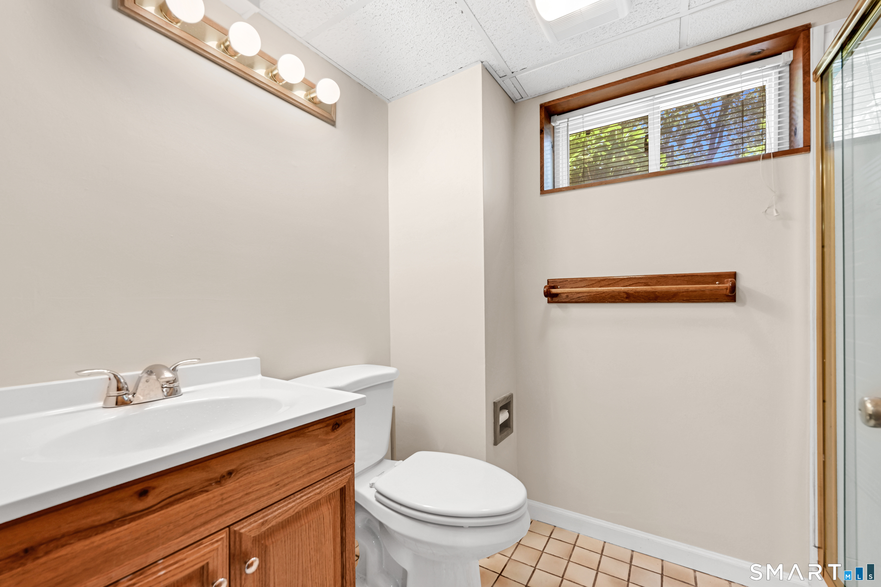 87 Lydall Road Newington, CT 06111 - Photo 23 of 35 a bathroom with a toilet a sink and a window