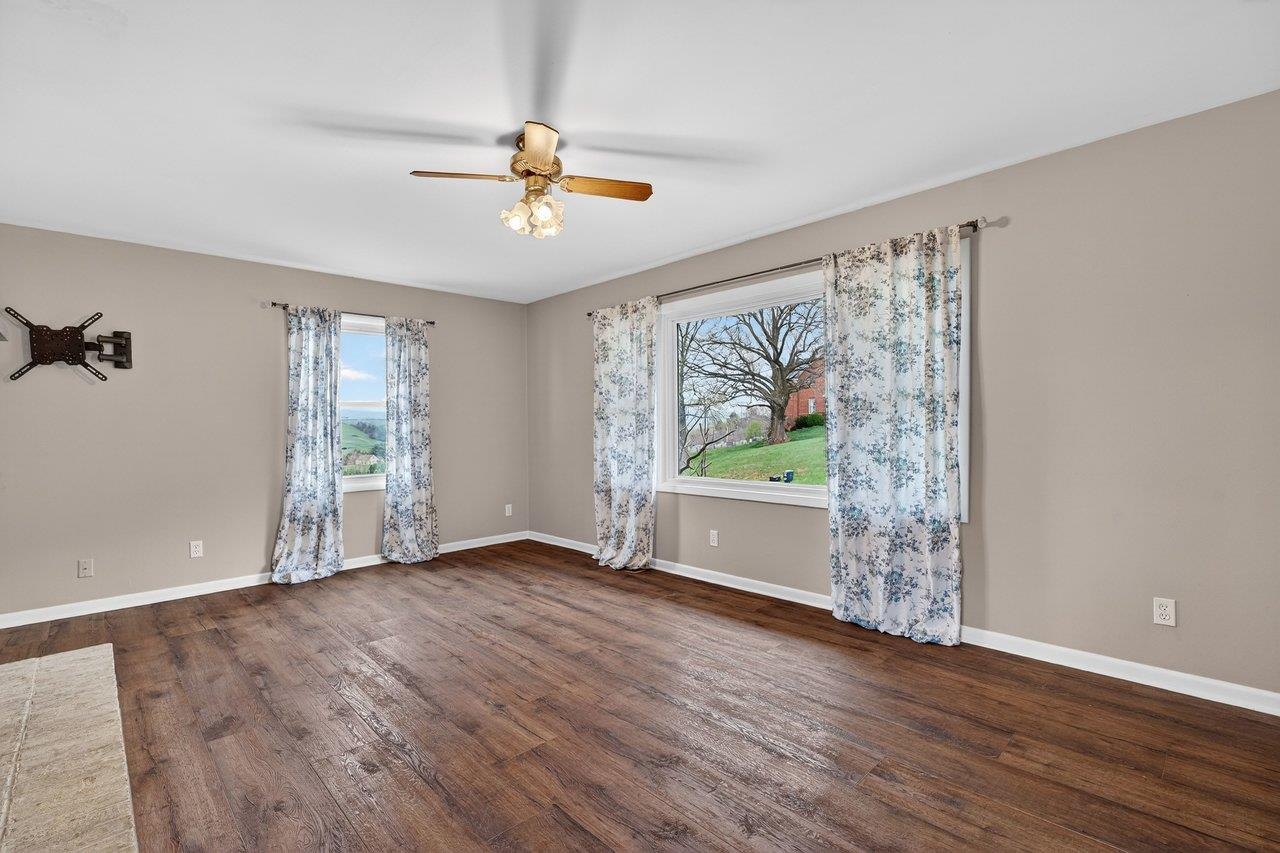 3259 Zion Church Road Broadway, VA 22815 - Photo 3 of 48 a view of an empty room with wooden floor and a window