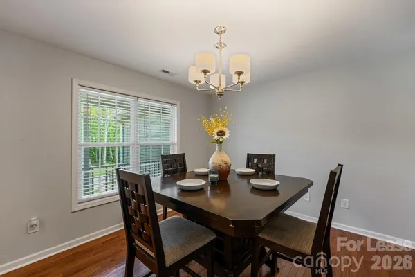 a view of a dining room with a table and chairs