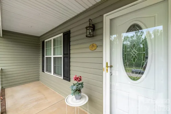 a view of a door and chair in the patio