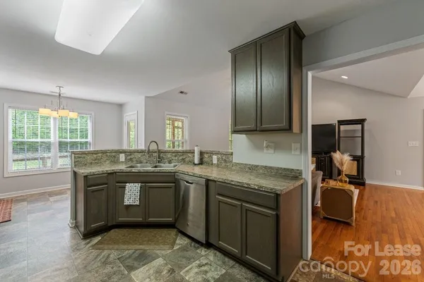 a kitchen with a stove sink and cabinets