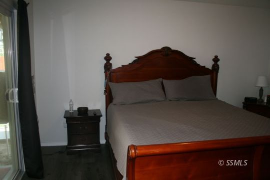 312 West Perdew Avenue Ridgecrest, CA 93555 - Photo 15 of 28 a bedroom with a bed and a night stand