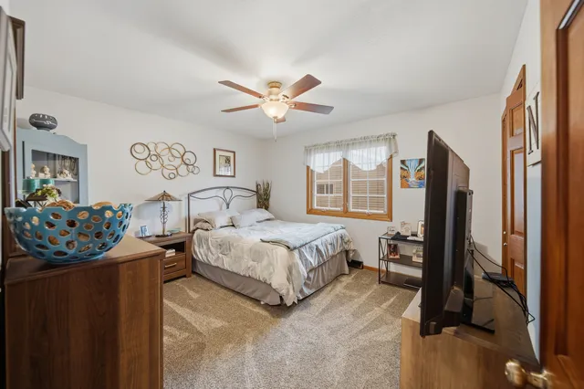 a bedroom with bed and a large window