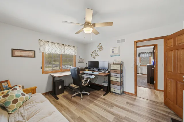 a workspace with wooden floor and a window