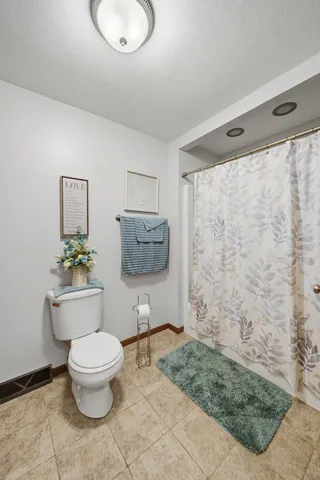 a bathroom with a toilet a sink and garden view