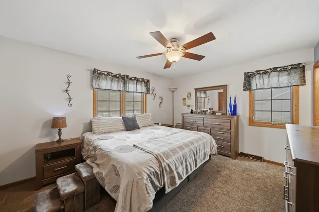 a bedroom with a large bed and a chandelier
