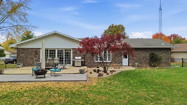 a view of a house with a yard and sitting area