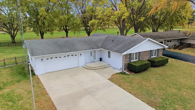 a view of house with yard and outdoor seating