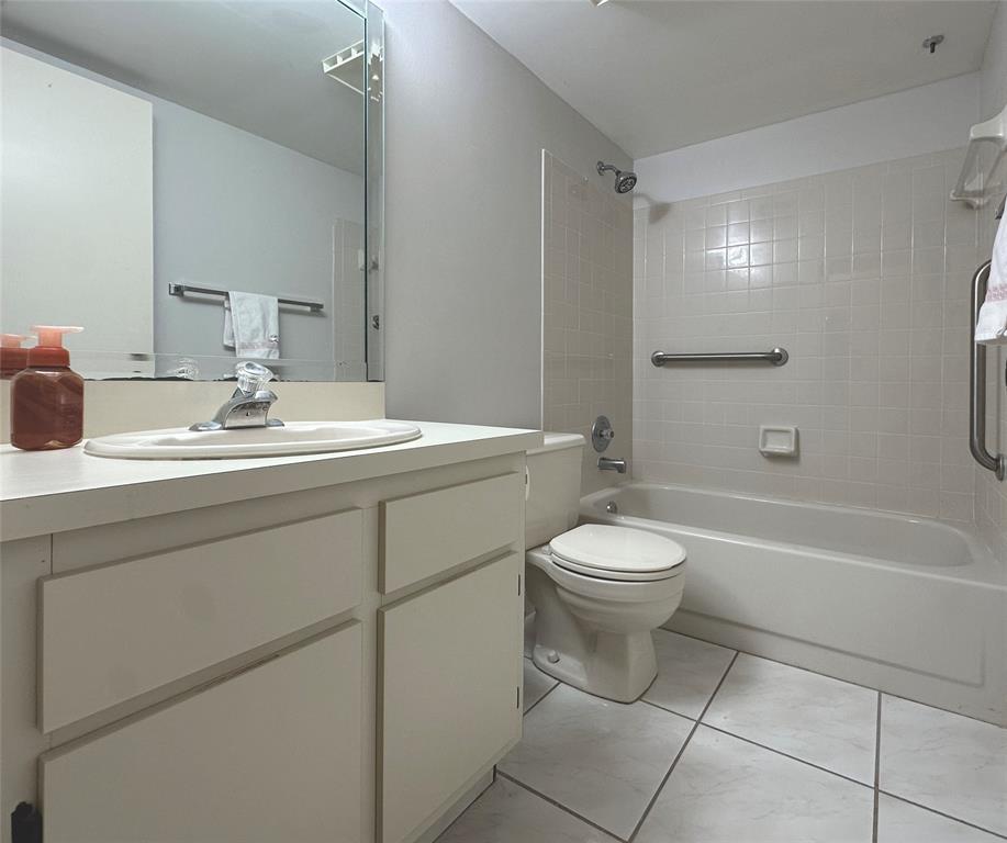 3001 Holiday Springs Boulevard, Unit 102 Margate, FL 33063 - Photo 12 of 18 a bathroom with a toilet sink vanity tub and shower