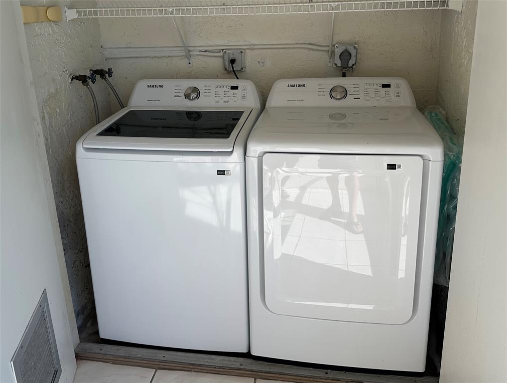 3001 Holiday Springs Boulevard, Unit 102 Margate, FL 33063 - Photo 17 of 18 a utility room with dryer and washer