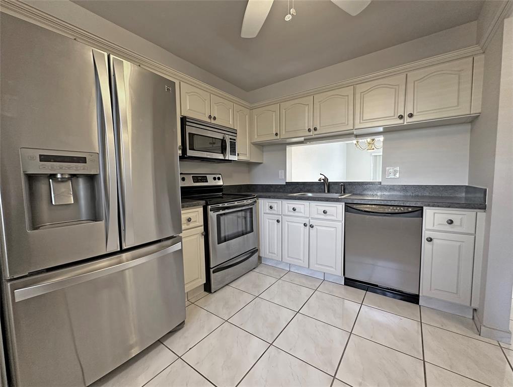 3001 Holiday Springs Boulevard, Unit 102 Margate, FL 33063 - Photo 3 of 18 a kitchen with stainless steel appliances granite countertop a refrigerator sink and stove