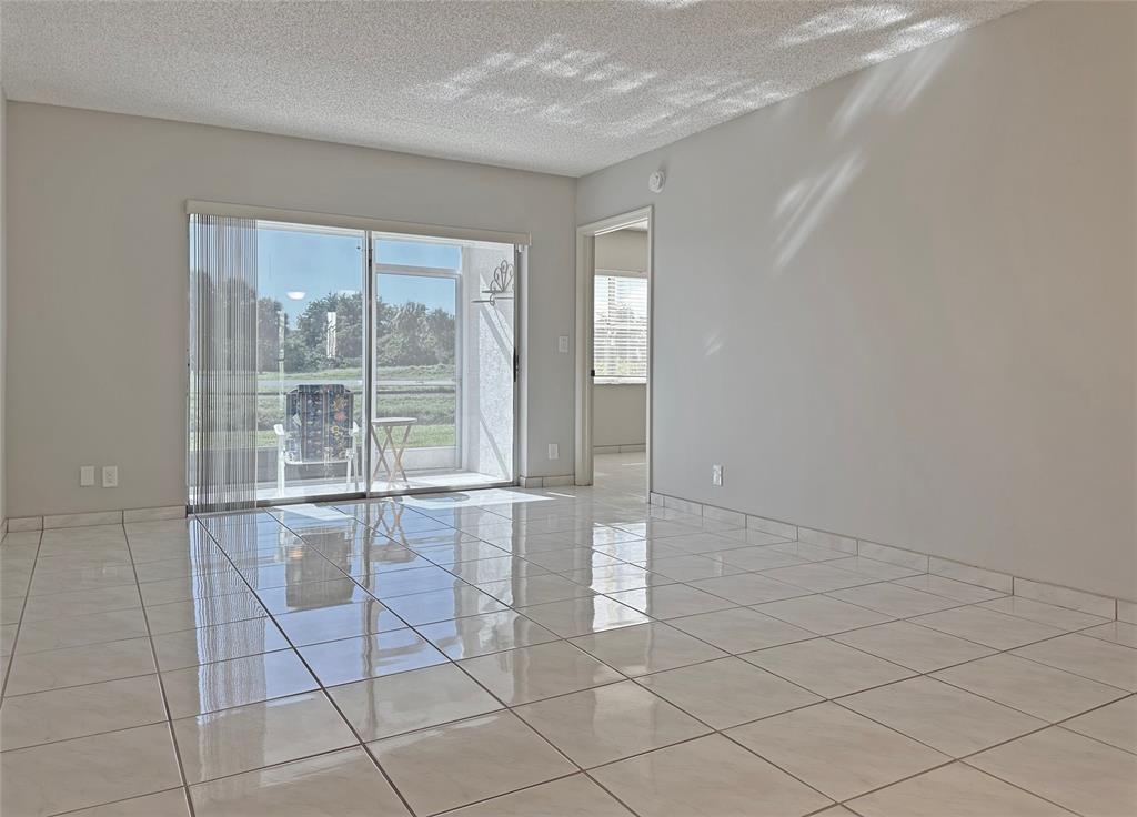 3001 Holiday Springs Boulevard, Unit 102 Margate, FL 33063 - Photo 5 of 18 a view of an empty room with a window