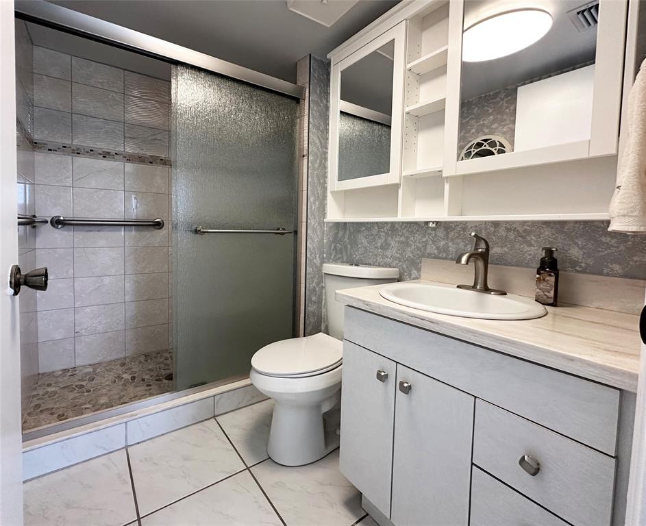 3001 Holiday Springs Boulevard, Unit 102 Margate, FL 33063 - Photo 10 of 18 a bathroom with a sink toilet and shower