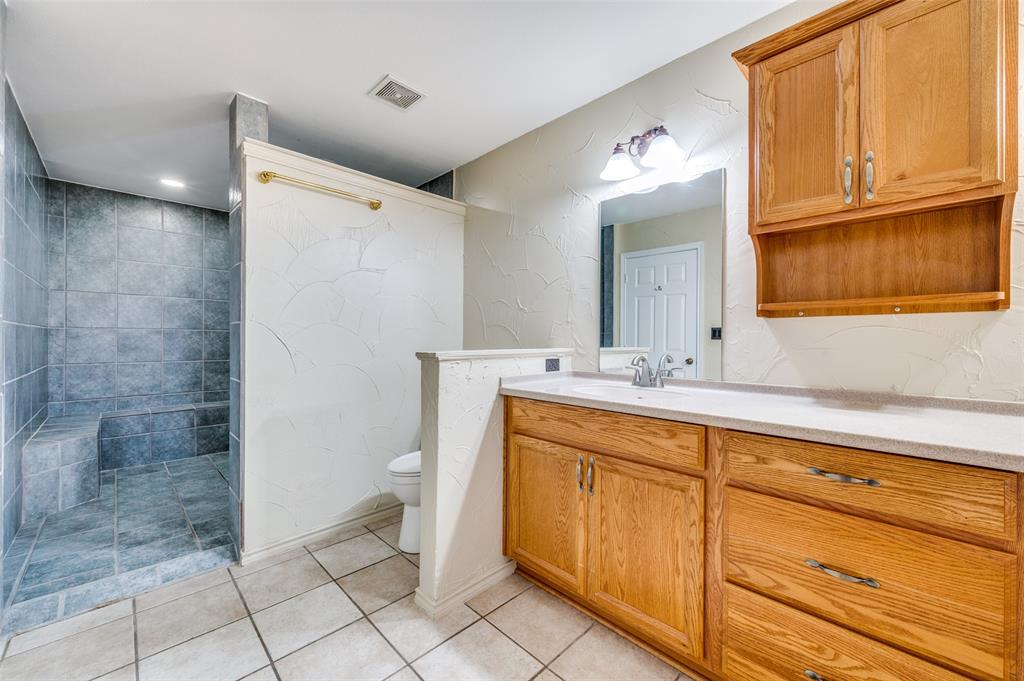7889 County Road 134 Celina, TX 75009 - Photo 20 of 36 a bathroom with a sink a toilet and a shower