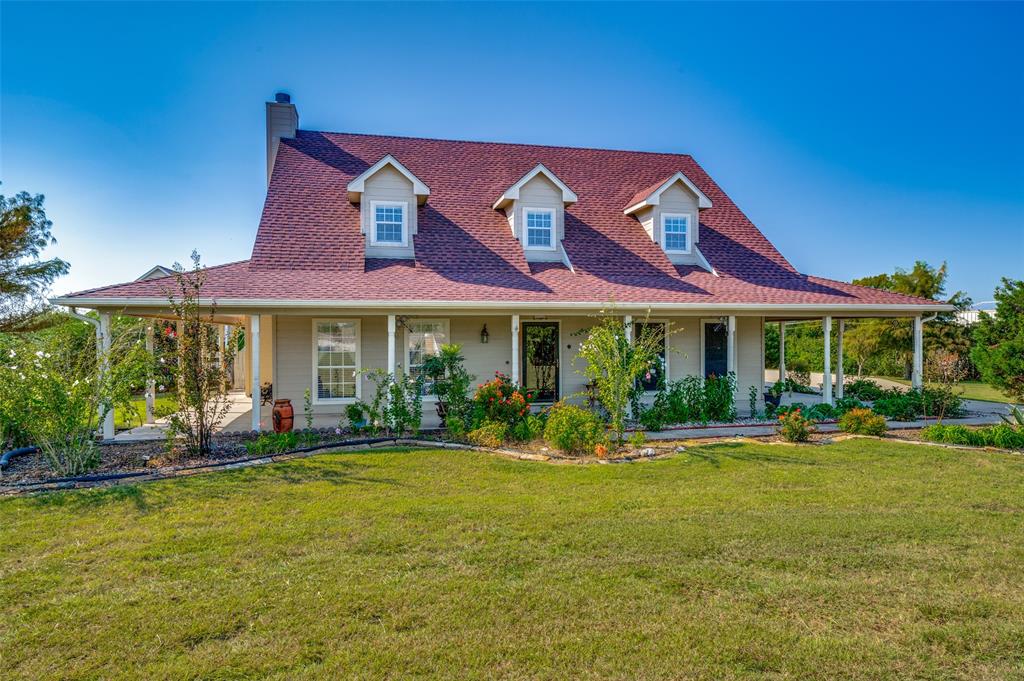 7889 County Road 134 Celina, TX 75009 - Photo 2 of 36 a front view of a building with a garden and plants