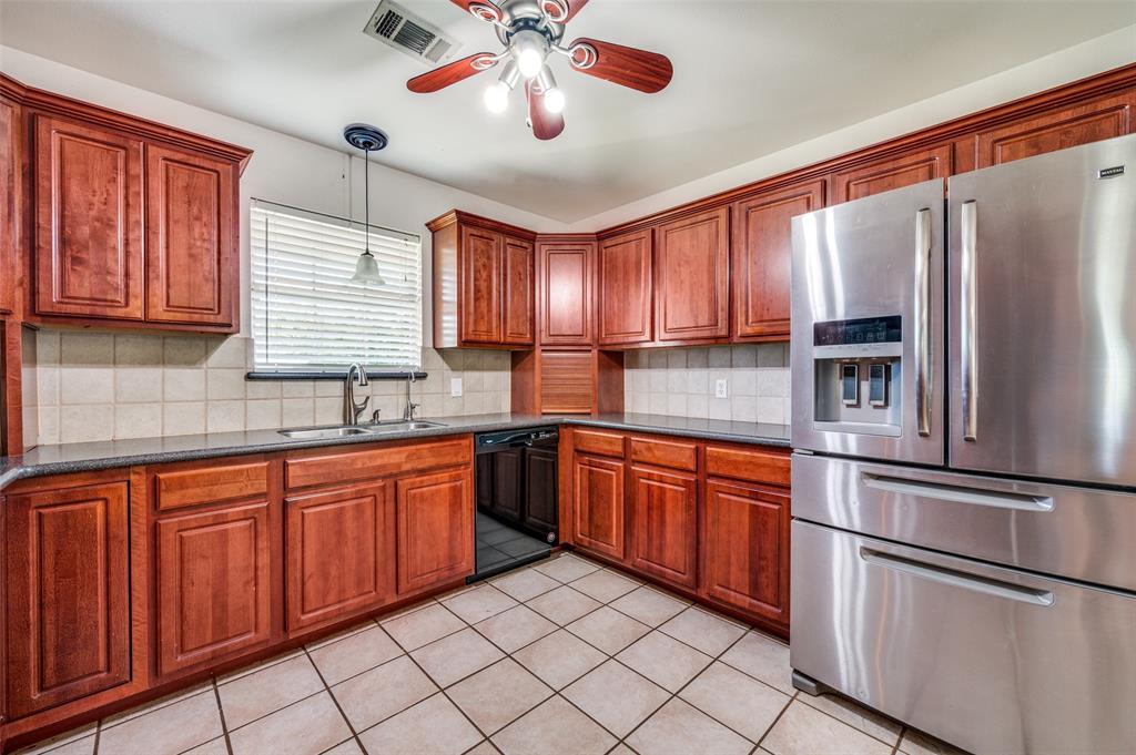 7889 County Road 134 Celina, TX 75009 - Photo 26 of 36 a kitchen with stainless steel appliances granite countertop a refrigerator and a sink