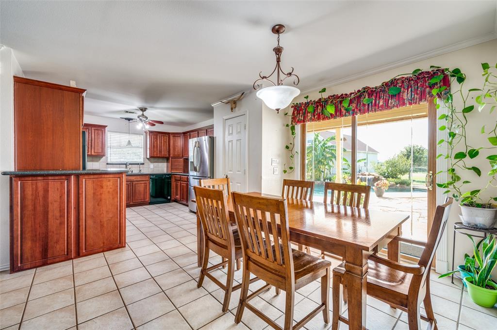 7889 County Road 134 Celina, TX 75009 - Photo 30 of 36 a view of a dining room and livingroom with furniture wooden floor a chandelier