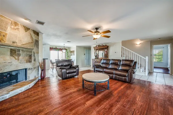 a living room with furniture a fireplace and a flat screen tv