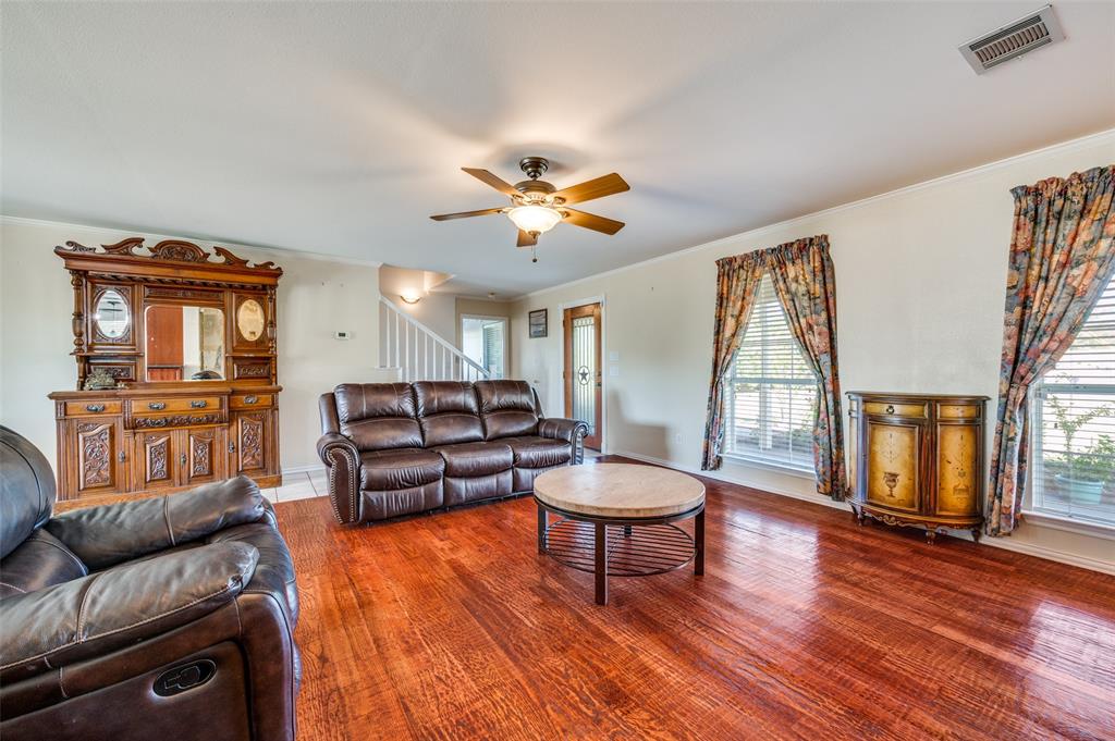 7889 County Road 134 Celina, TX 75009 - Photo 34 of 36 a living room with furniture and a fireplace