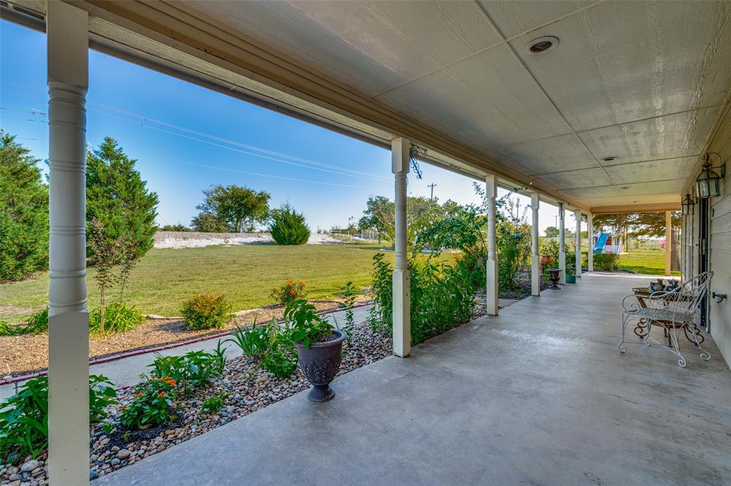 7889 County Road 134 Celina, TX 75009 - Photo 36 of 36 a view of a patio with lawn chairs next to a yard