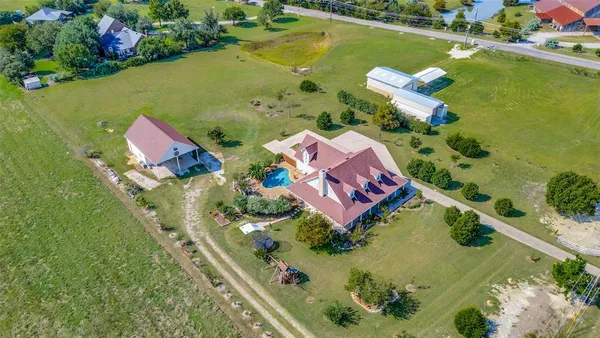 an aerial view of a houses with outdoor space swimming pool and ocean view