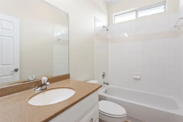 a view of a house with a big yard and large tree