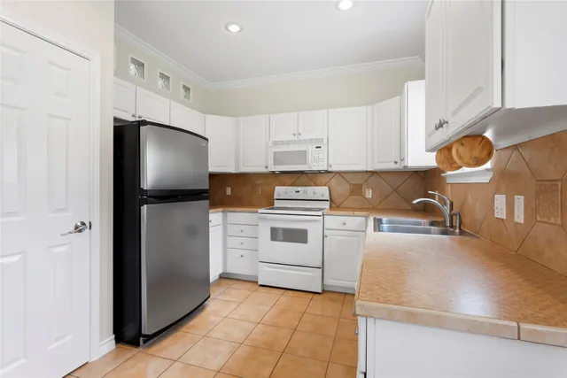 a bathroom with a granite countertop toilet sink and mirror