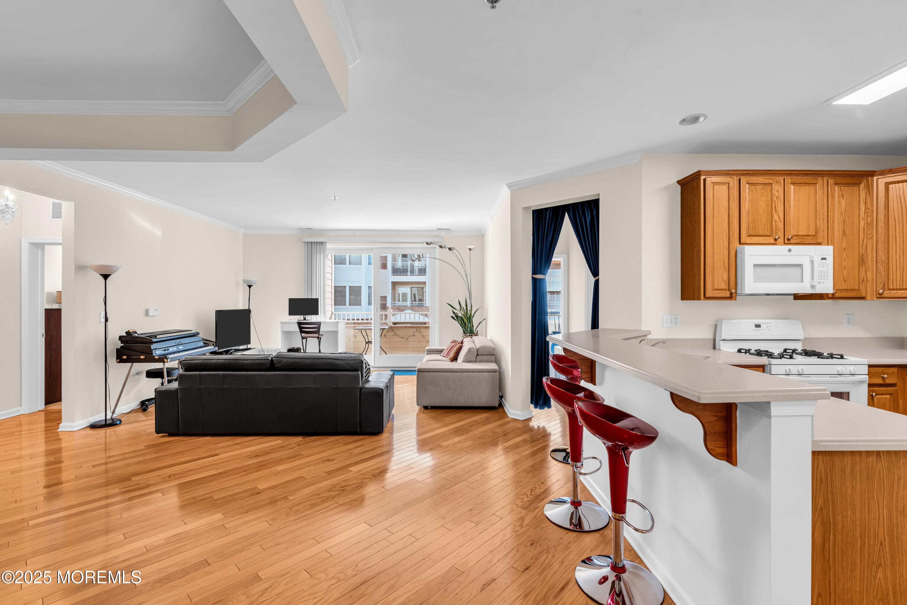 33 Cooper Avenue, Unit 210 Long Branch, NJ 07740 - Photo 4 of 12 a living room with furniture and a wooden floor
