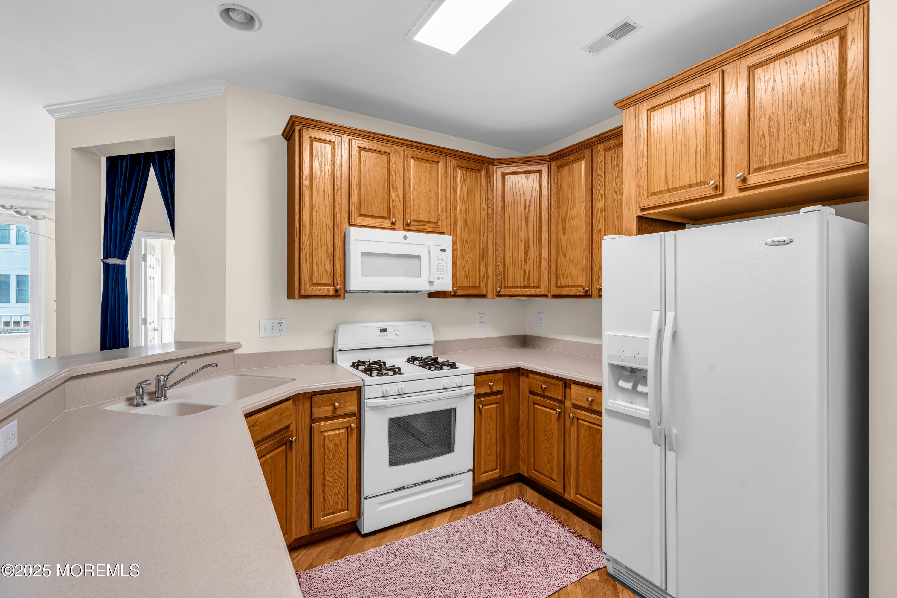 33 Cooper Avenue, Unit 210 Long Branch, NJ 07740 - Photo 5 of 12 a kitchen with stainless steel appliances granite countertop a stove a sink dishwasher and a refrigerator