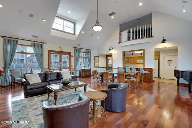 a living room with fireplace furniture and a large window