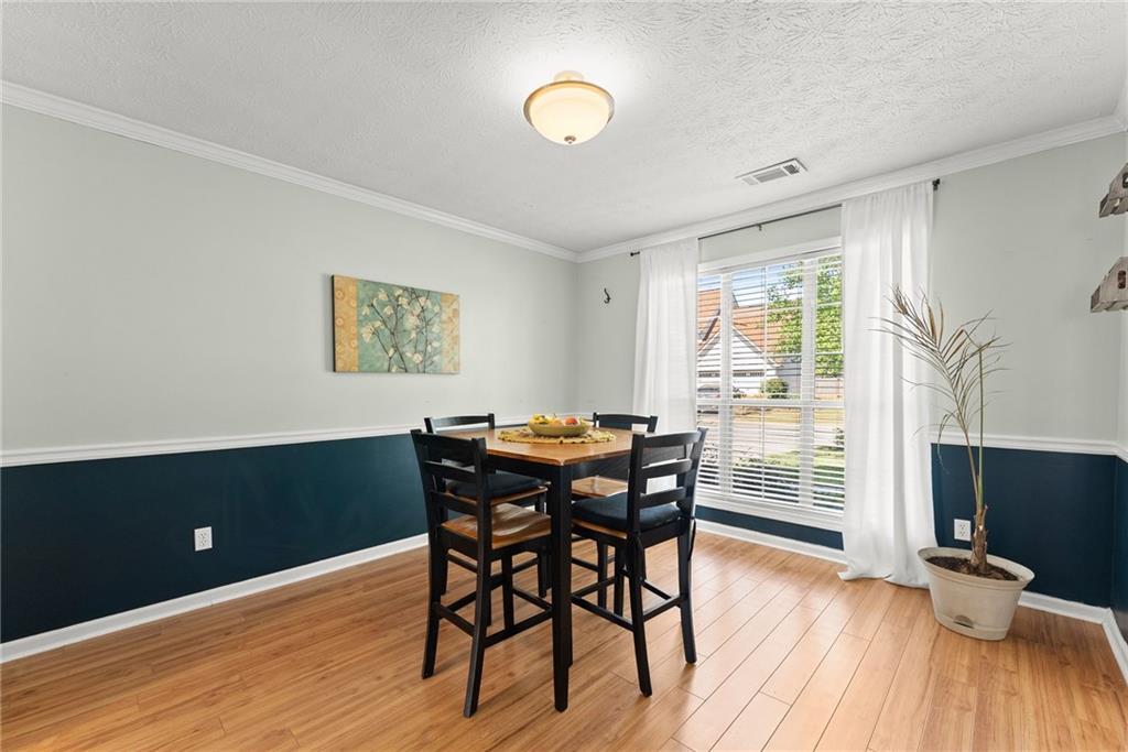4055 Ivy Run Circle Duluth, GA 30096 - Photo 13 of 55 a view of a dining room with furniture and wooden floor
