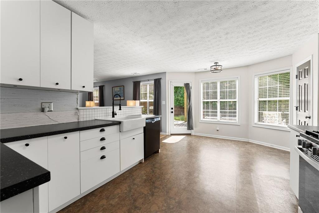 4055 Ivy Run Circle Duluth, GA 30096 - Photo 15 of 55 a kitchen with granite countertop white cabinets and sink