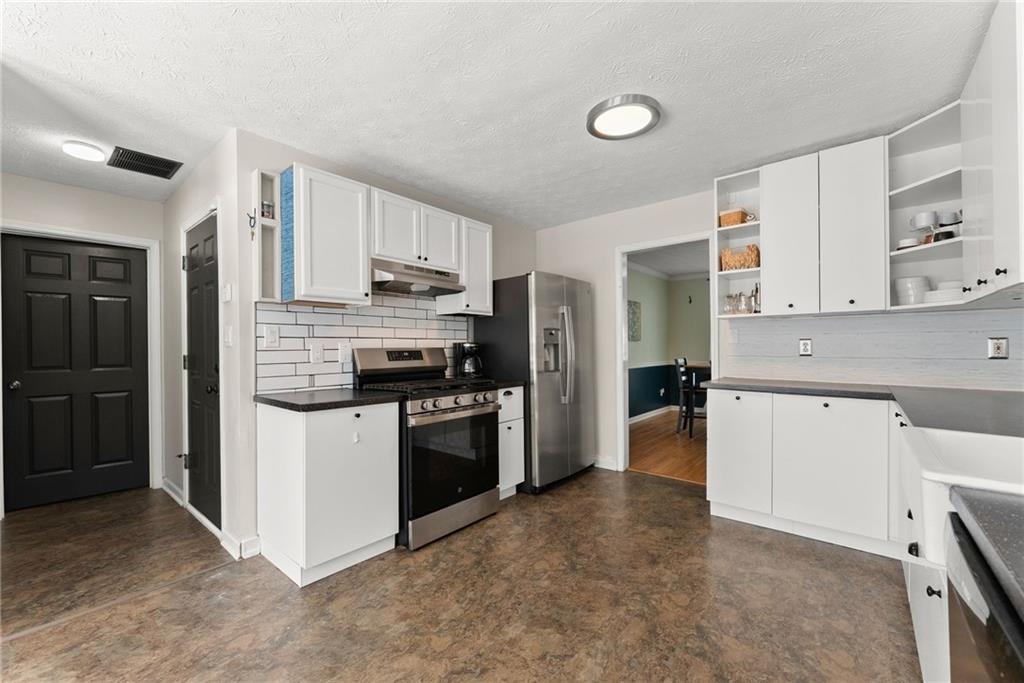 4055 Ivy Run Circle Duluth, GA 30096 - Photo 16 of 55 a kitchen with a refrigerator stove top oven and sink