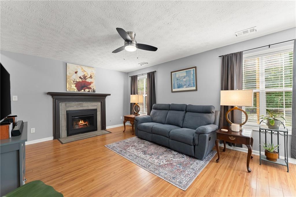 4055 Ivy Run Circle Duluth, GA 30096 - Photo 20 of 55 a living room with furniture and a fireplace