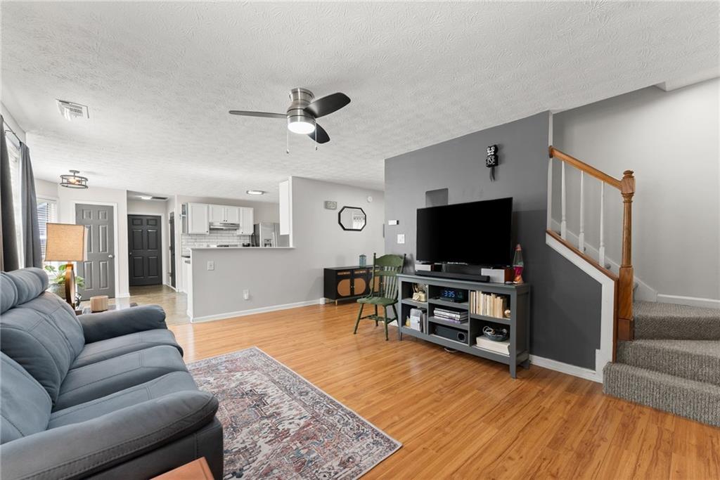 4055 Ivy Run Circle Duluth, GA 30096 - Photo 21 of 55 a living room with furniture and a flat screen tv