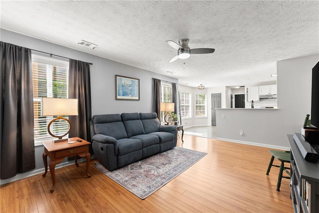 4055 Ivy Run Circle Duluth, GA 30096 - Photo 22 of 55 a living room with furniture and a wooden floor