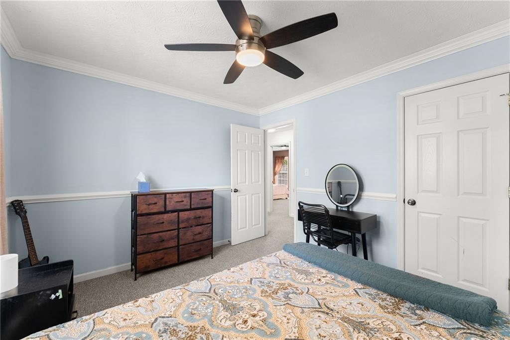 4055 Ivy Run Circle Duluth, GA 30096 - Photo 29 of 55 a bedroom with a bed and a chandelier