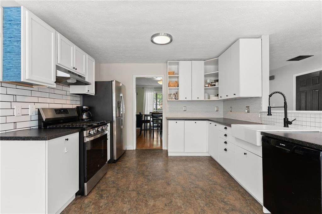 4055 Ivy Run Circle Duluth, GA 30096 - Photo 3 of 55 a kitchen with stainless steel appliances granite countertop a sink stove and refrigerator