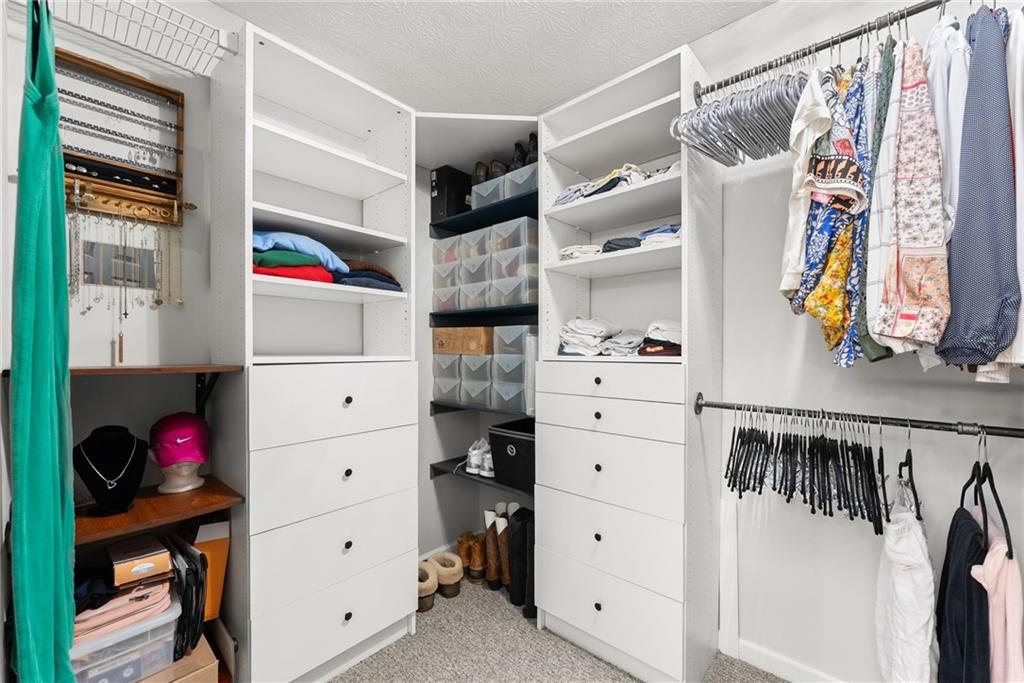 4055 Ivy Run Circle Duluth, GA 30096 - Photo 33 of 55 a view of walk in closet with clothes and shoes