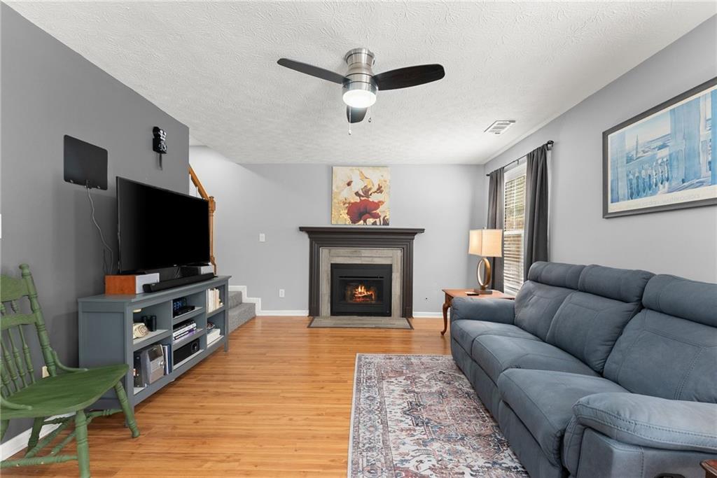 4055 Ivy Run Circle Duluth, GA 30096 - Photo 4 of 55 a living room with furniture a flat screen tv and a fireplace