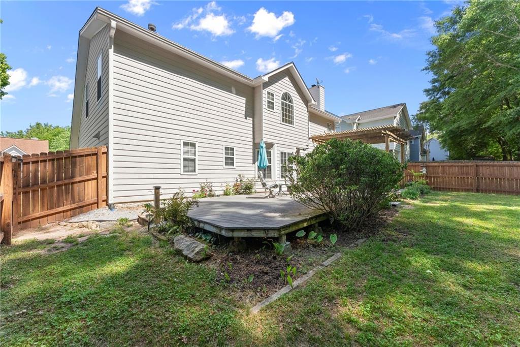 4055 Ivy Run Circle Duluth, GA 30096 - Photo 43 of 55 a view of a backyard with table and chairs and wooden fence