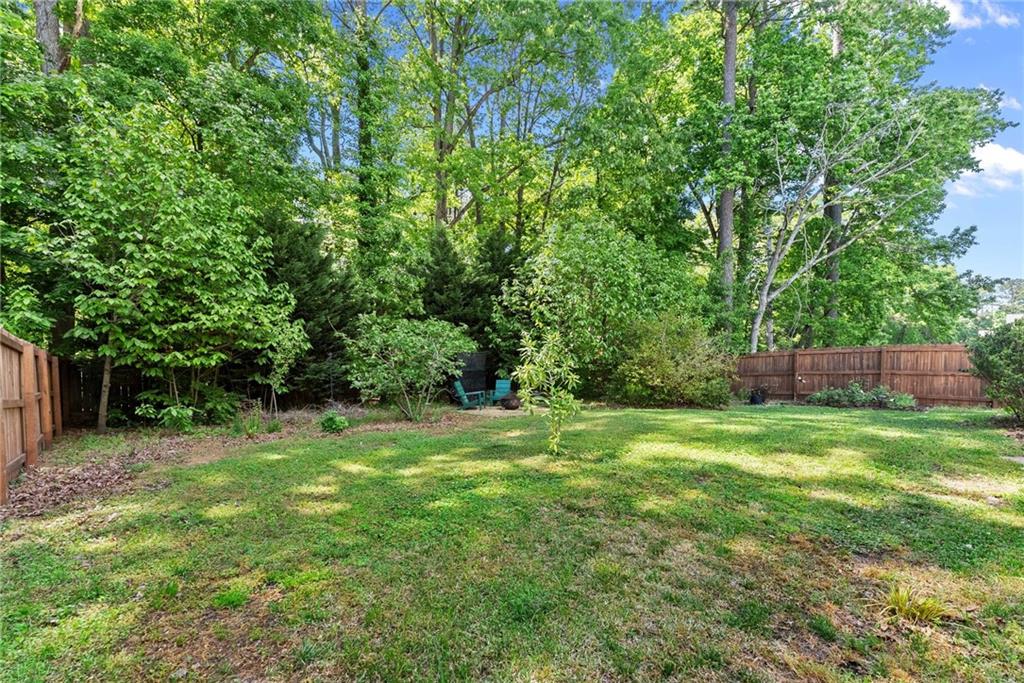 4055 Ivy Run Circle Duluth, GA 30096 - Photo 46 of 55 a backyard of a house with plants and large trees